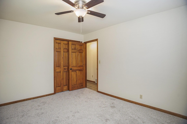 15035 155th Ave, Grand Haven, MI 49417 - unfurnished bedroom with carpet flooring, baseboards, a closet, and a ceiling fan