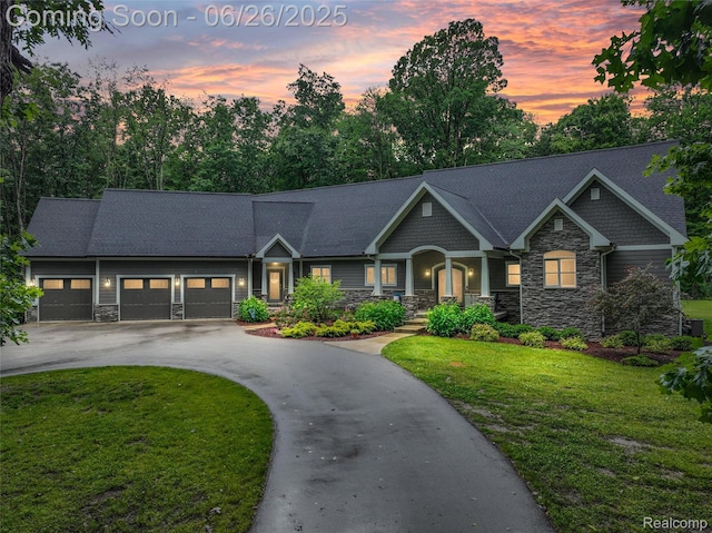 800 Greystone Dr, Chelsea, MI 48118 - view of front of property with stone siding, asphalt driveway, a lawn, an attached garage, and a porch