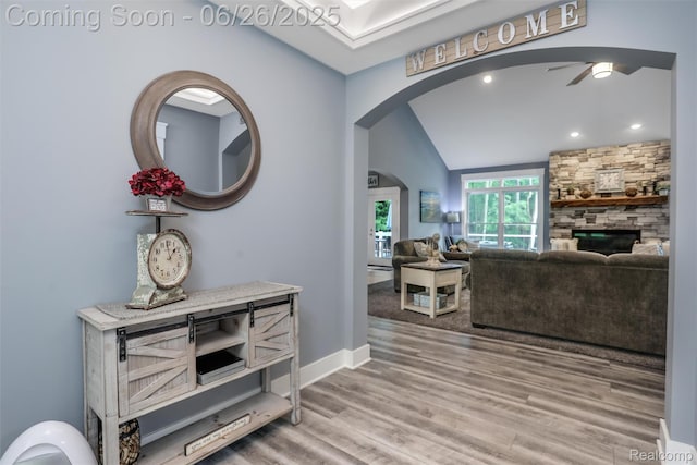 800 Greystone Dr, Chelsea, MI 48118 - hall featuring arched walkways, vaulted ceiling, wood finished floors, and recessed lighting