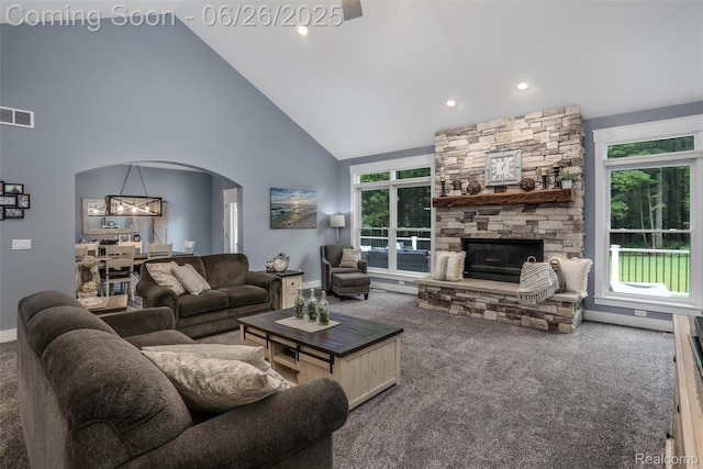 800 Greystone Dr, Chelsea, MI 48118 - carpeted living area with high vaulted ceiling, arched walkways, plenty of natural light, a stone fireplace, and recessed lighting