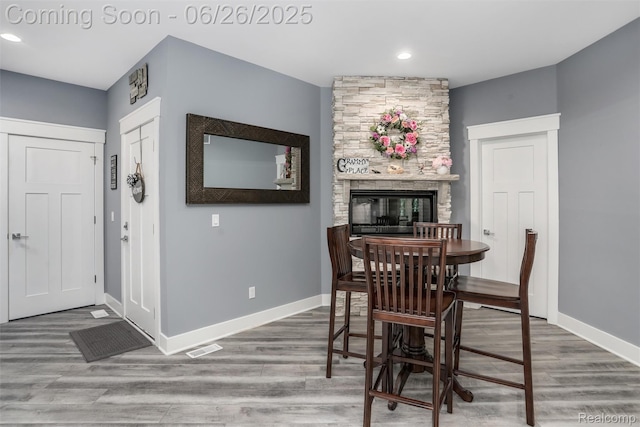 800 Greystone Dr, Chelsea, MI 48118 - dining area featuring wood finished floors, recessed lighting, and a stone fireplace