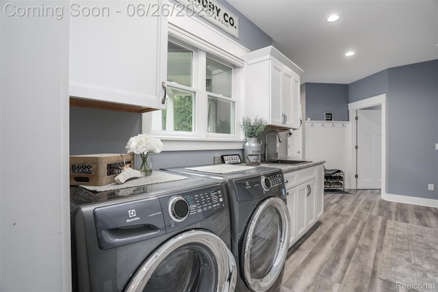800 Greystone Dr, Chelsea, MI 48118 - laundry room featuring separate washer and dryer, cabinet space, light wood-style floors, and recessed lighting