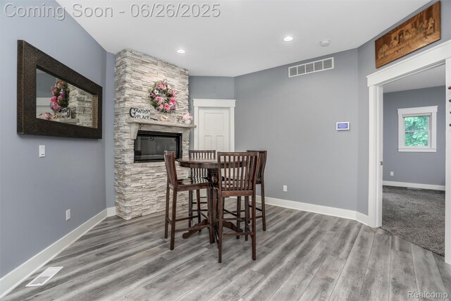 800 Greystone Dr, Chelsea, MI 48118 - dining room featuring wood finished floors, a fireplace, and recessed lighting