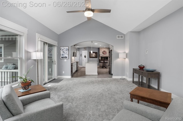 800 Greystone Dr, Chelsea, MI 48118 - living room with carpet flooring, arched walkways, a ceiling fan, and lofted ceiling
