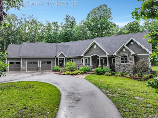 800 Greystone Dr, Chelsea, MI 48118 - craftsman inspired home with stone siding, an attached garage, a front yard, driveway, and covered porch