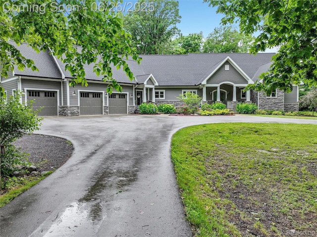 800 Greystone Dr, Chelsea, MI 48118 - view of front of property featuring stone siding, asphalt driveway, a garage, a front lawn, and roof with shingles