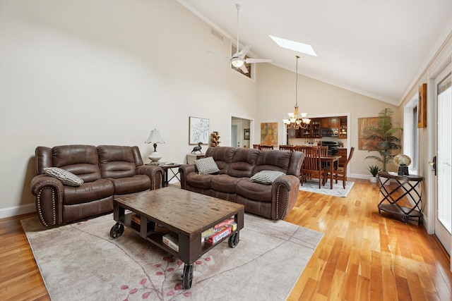 16350 Whitaker Rd, Linden, MI 48451 - living room featuring a chandelier, a skylight, high vaulted ceiling, a ceiling fan, and light wood finished floors