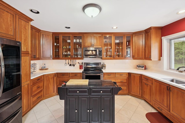 16350 Whitaker Rd, Linden, MI 48451 - kitchen featuring stainless steel appliances, a sink, brown cabinetry, light tile patterned floors, and recessed lighting