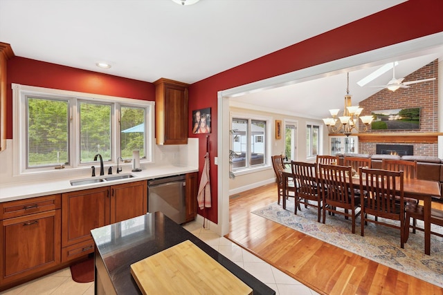 16350 Whitaker Rd, Linden, MI 48451 - kitchen with stainless steel dishwasher, a sink, a chandelier, light countertops, and baseboards