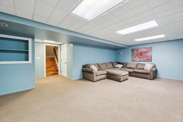 16350 Whitaker Rd, Linden, MI 48451 - carpeted living area featuring stairs, baseboards, and a paneled ceiling