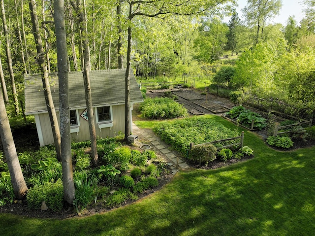 11775 Crystal Ridge Dr NE, Sparta, MI 49345 - view of grassy yard with a vegetable garden and a view of trees