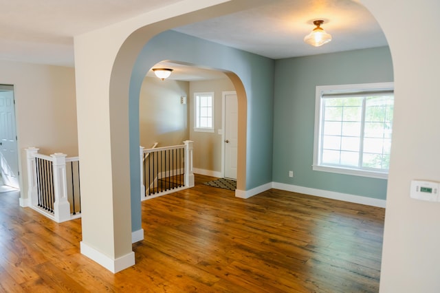 11775 Crystal Ridge Dr NE, Sparta, MI 49345 - unfurnished room featuring wood finished floors, baseboards, and arched walkways