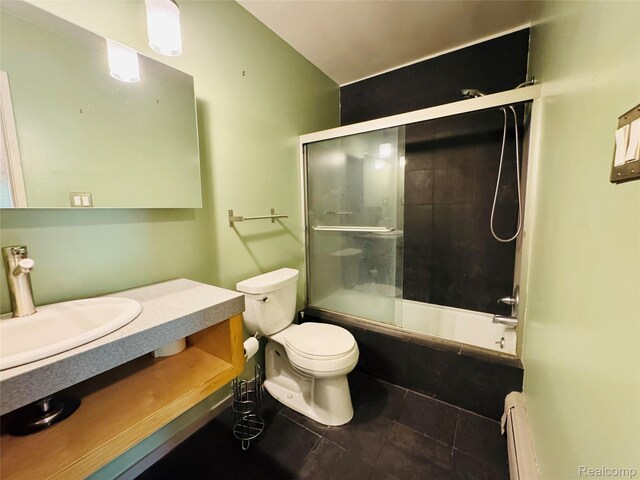 32040 Grand River Ave Unit 47, Farmington, MI 48336 - full bathroom featuring baseboard heating, toilet, enclosed tub / shower combo, tile patterned flooring, and vanity