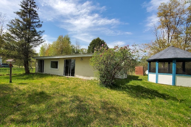 599 Ruby Rd, Sheridan, MI 48884 - back of house with a gazebo and stucco siding