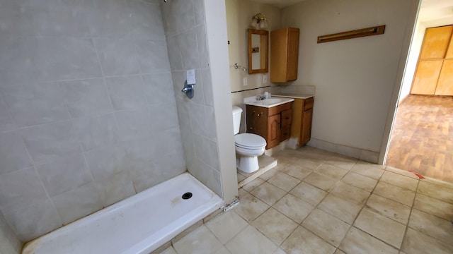 599 Ruby Rd, Sheridan, MI 48884 - bathroom with vanity, toilet, a tile shower, and tile patterned flooring