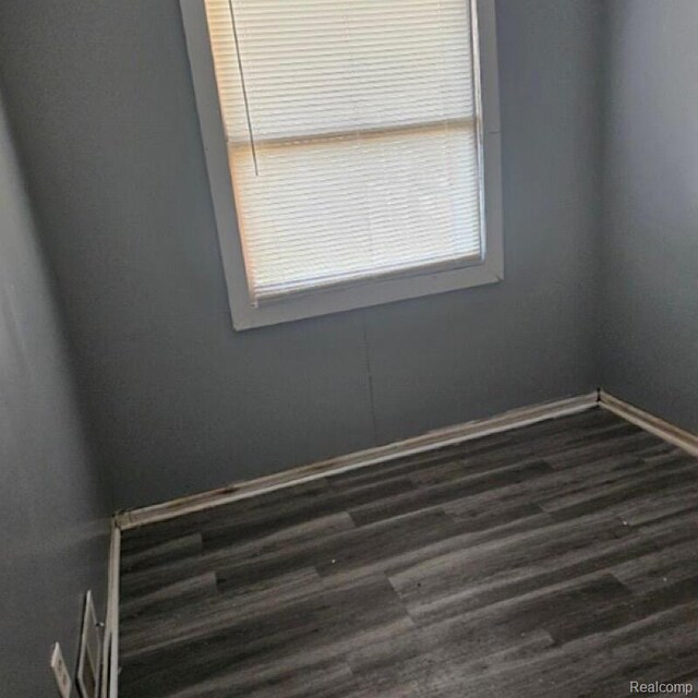 28632 Hazelwood St, Detroit, MI 48141 - empty room featuring dark wood-style floors and baseboards