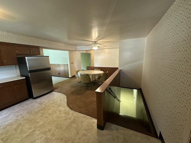 388 Richard St, Spring Arbor, MI 49283 - kitchen with freestanding refrigerator, wallpapered walls, dark brown cabinetry, and ceiling fan