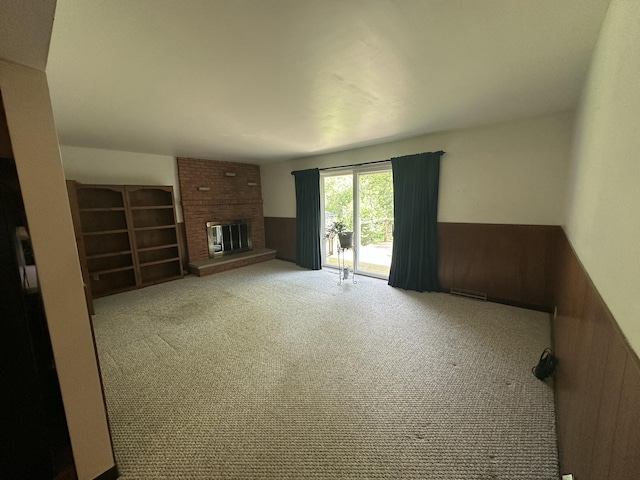 388 Richard St, Spring Arbor, MI 49283 - unfurnished living room with a fireplace, carpet flooring, and wainscoting
