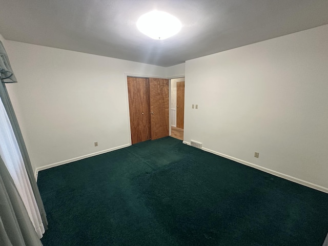388 Richard St, Spring Arbor, MI 49283 - unfurnished bedroom featuring a closet, dark carpet, and baseboards