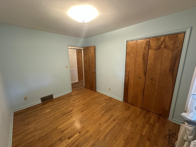 388 Richard St, Spring Arbor, MI 49283 - unfurnished bedroom featuring light wood-style floors, baseboards, and a closet