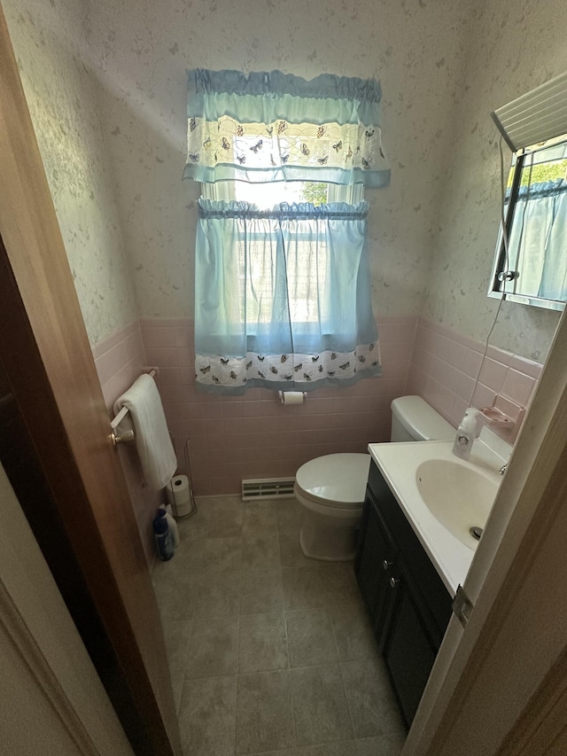 388 Richard St, Spring Arbor, MI 49283 - bathroom featuring a wainscoted wall, toilet, wallpapered walls, vanity, and tile walls