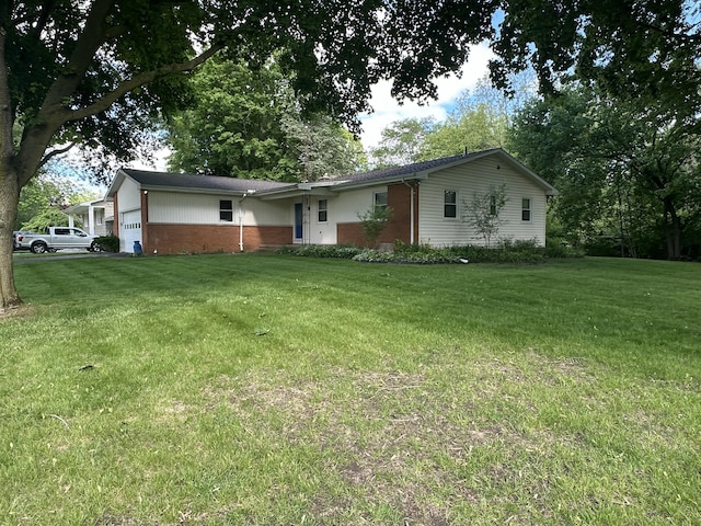 388 Richard St, Spring Arbor, MI 49283 - ranch-style house with a garage, brick siding, and a front yard