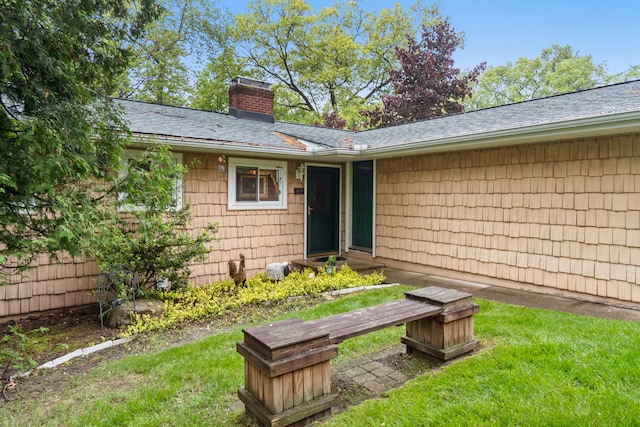 11676 Bradley Dr, Jerome, MI 49249 - doorway to property with a chimney and a shingled roof