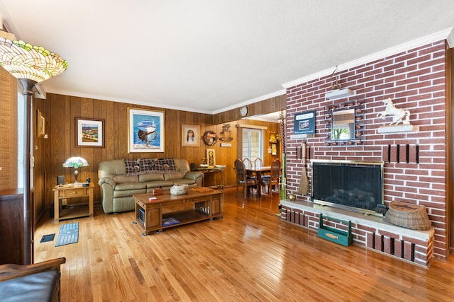 11676 Bradley Dr, Jerome, MI 49249 - living area featuring ornamental molding, wood finished floors, wood walls, and a fireplace