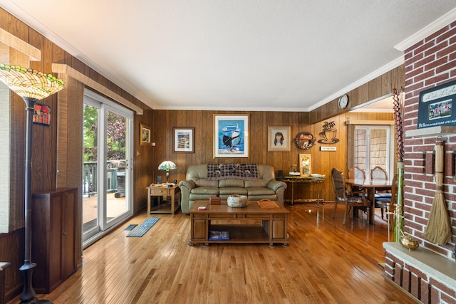 11676 Bradley Dr, Jerome, MI 49249 - living room with ornamental molding, wood walls, and wood-type flooring
