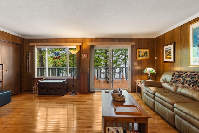 11676 Bradley Dr, Jerome, MI 49249 - living area with wooden walls, crown molding, hardwood / wood-style flooring, and a textured ceiling