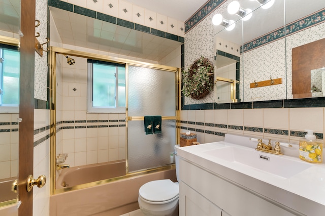 11676 Bradley Dr, Jerome, MI 49249 - bathroom featuring toilet, vanity, tile walls, and enclosed tub / shower combo