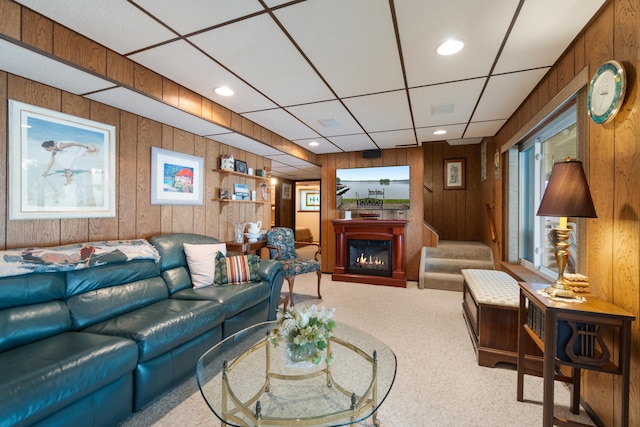 11676 Bradley Dr, Jerome, MI 49249 - carpeted living room featuring wooden walls, a glass covered fireplace, and recessed lighting