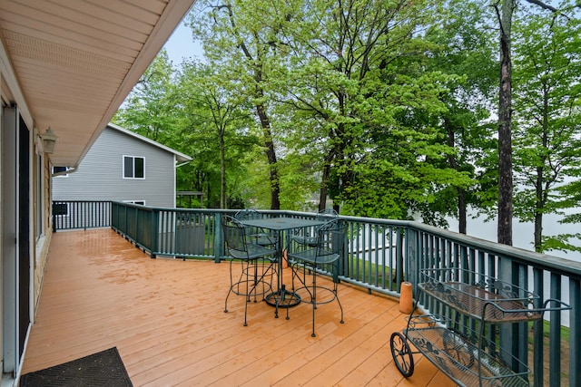11676 Bradley Dr, Jerome, MI 49249 - wooden terrace with outdoor dining area and view of scattered trees