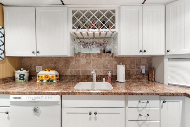 11676 Bradley Dr, Jerome, MI 49249 - kitchen with dishwasher, a sink, white cabinetry, and backsplash