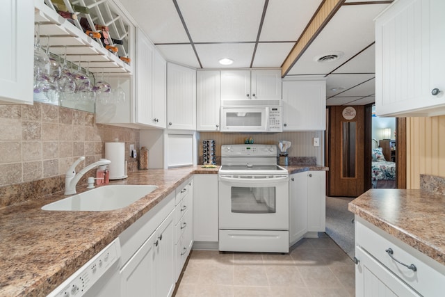 11676 Bradley Dr, Jerome, MI 49249 - kitchen featuring white appliances, a sink, a drop ceiling, white cabinets, and light tile patterned floors