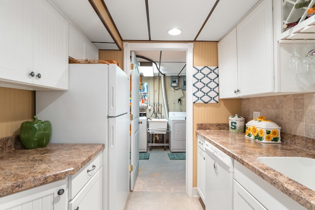 11676 Bradley Dr, Jerome, MI 49249 - kitchen featuring washer / clothes dryer, white dishwasher, white cabinets, a sink, and light countertops