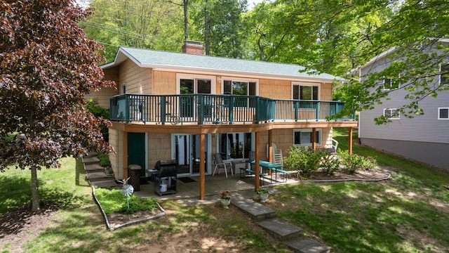 11676 Bradley Dr, Jerome, MI 49249 - back of house with a chimney, a patio area, a deck, and a lawn