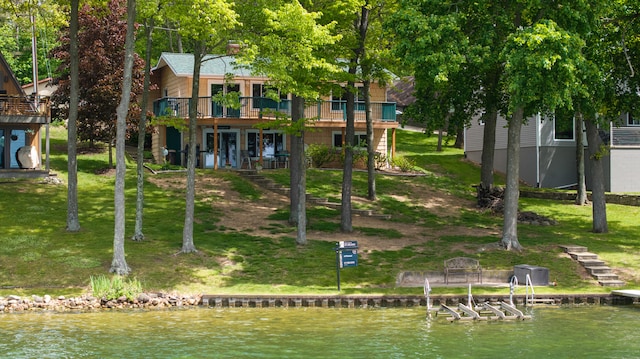 11676 Bradley Dr, Jerome, MI 49249 - back of house featuring stairway, a deck with water view, and a yard