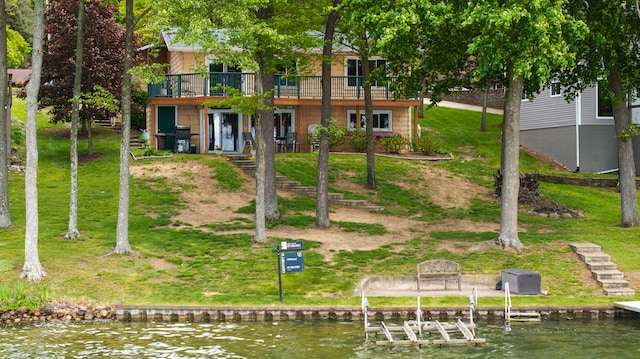 11676 Bradley Dr, Jerome, MI 49249 - back of property with a deck with water view, boat lift, and a yard