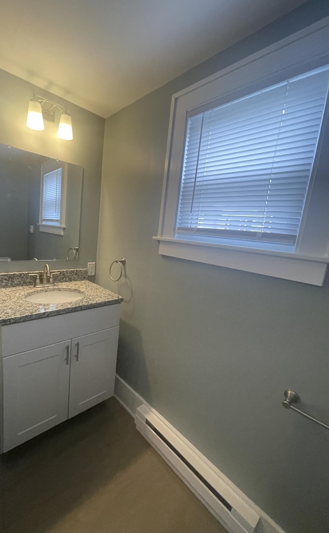 1007 Alto Ave SE, Grand Rapids, MI 49507 - bathroom featuring a baseboard heating unit, vanity, and baseboards