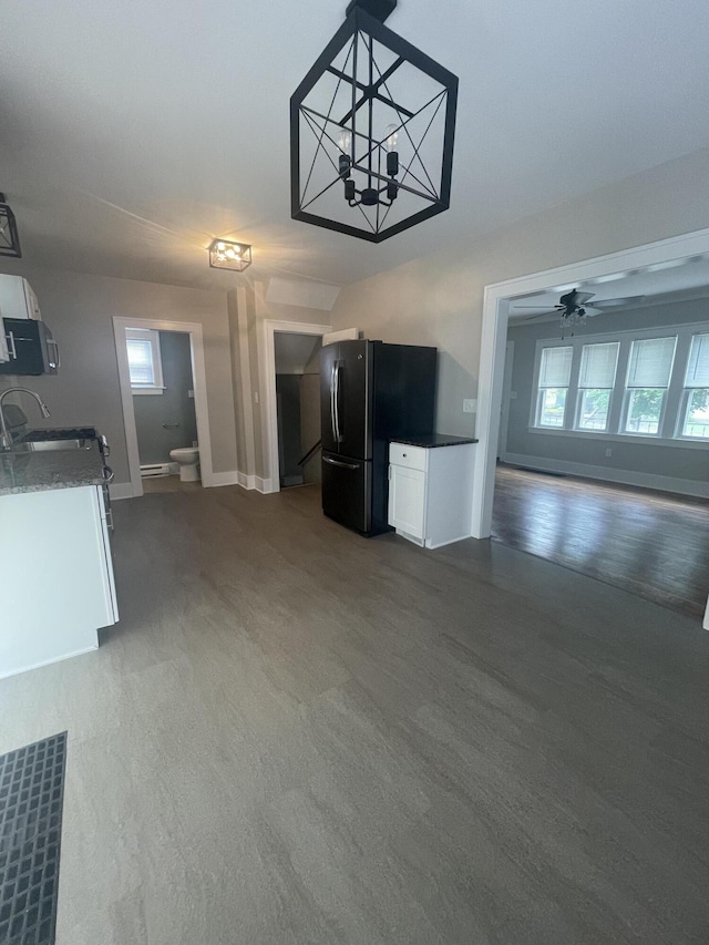 1007 Alto Ave SE, Grand Rapids, MI 49507 - unfurnished living room with a sink, baseboards, ceiling fan, and baseboard heating