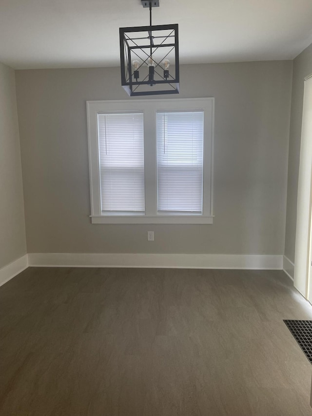 1007 Alto Ave SE, Grand Rapids, MI 49507 - spare room featuring a chandelier and baseboards