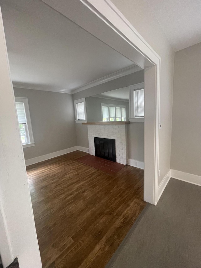 1007 Alto Ave SE, Grand Rapids, MI 49507 - unfurnished living room with baseboards, a fireplace, crown molding, healthy amount of natural light, and wood finished floors