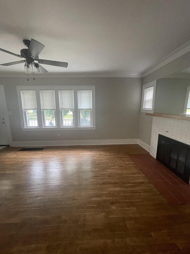1007 Alto Ave SE, Grand Rapids, MI 49507 - unfurnished living room featuring crown molding, baseboards, a brick fireplace, dark wood finished floors, and ceiling fan