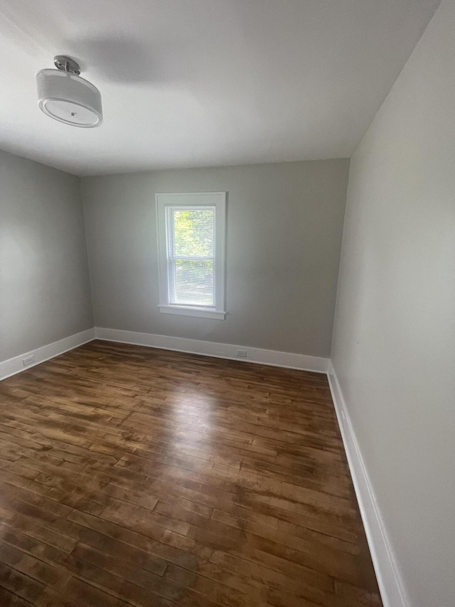 1007 Alto Ave SE, Grand Rapids, MI 49507 - empty room featuring dark wood-type flooring and baseboards