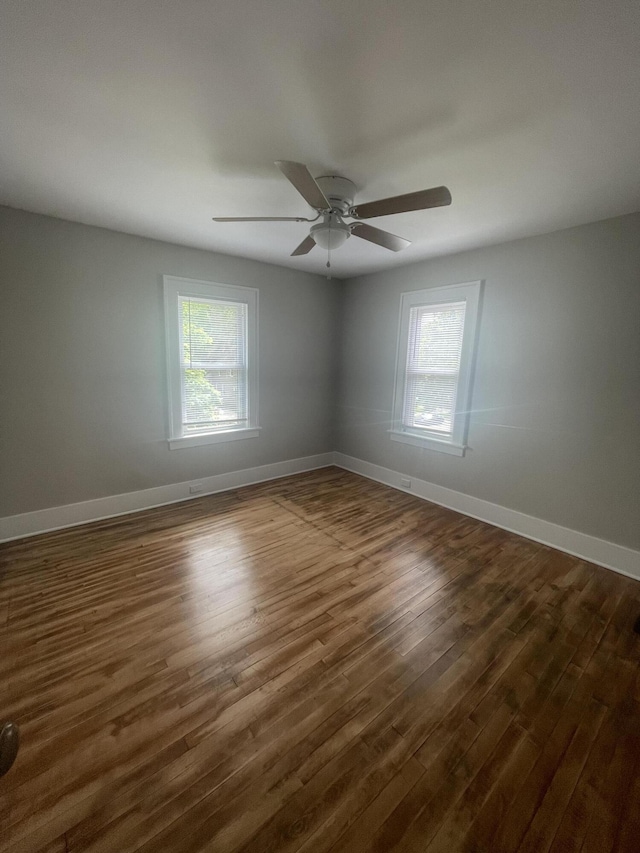 1007 Alto Ave SE, Grand Rapids, MI 49507 - spare room with dark wood-style floors, healthy amount of natural light, baseboards, and a ceiling fan