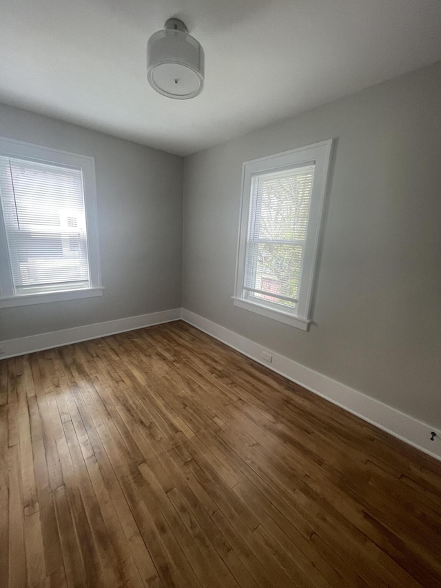 1007 Alto Ave SE, Grand Rapids, MI 49507 - spare room featuring healthy amount of natural light, wood-type flooring, and baseboards
