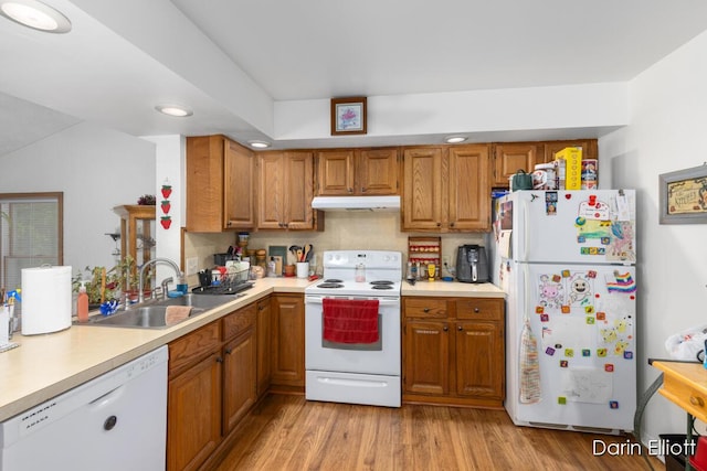 604/606 N New Dexter St, Ionia, MI 48846 - kitchen featuring white appliances, under cabinet range hood, a sink, light countertops, and light wood-style floors