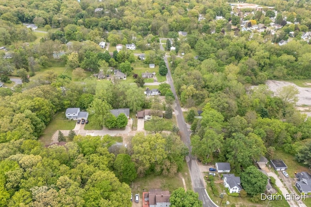 604/606 N New Dexter St, Ionia, MI 48846 - aerial view of property and surrounding area featuring a heavily wooded area and nearby suburban area