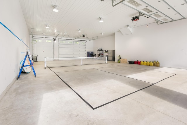67881 Edgewater Beach Rd, White Pigeon, MI 49099 - garage featuring a garage door opener and freestanding refrigerator